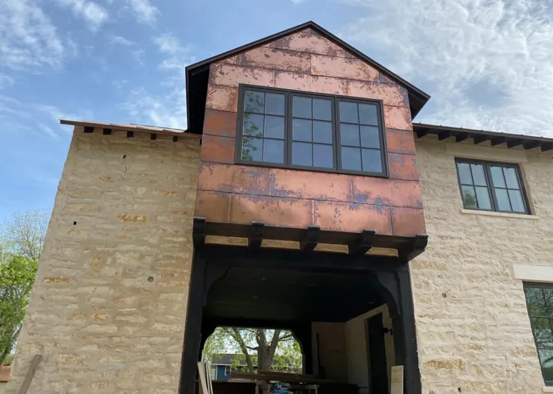 Copper metal panel facade on a stone building for Skylight Installation in Security-Widefield